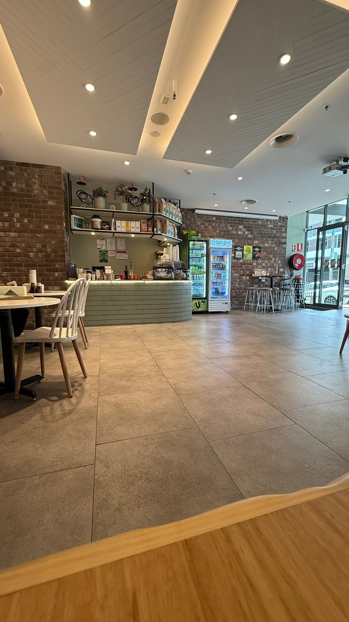YOUIES - Vibrant cafe entrance with modern decor and welcoming atmosphere in Belmore